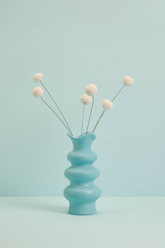 White Craspedia in blue vase